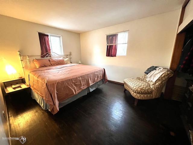 bedroom with dark hardwood / wood-style floors