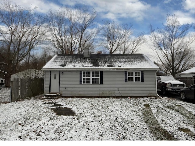 view of snow covered back of property