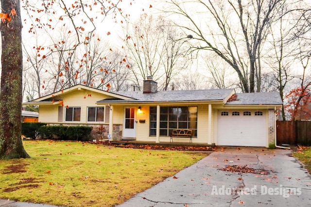 ranch-style home featuring a front lawn and a garage