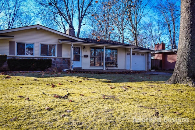 ranch-style home featuring a garage and a front lawn