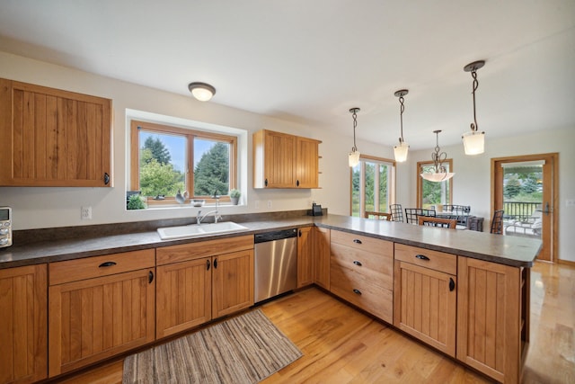 kitchen with dishwasher, sink, light wood-type flooring, kitchen peninsula, and pendant lighting