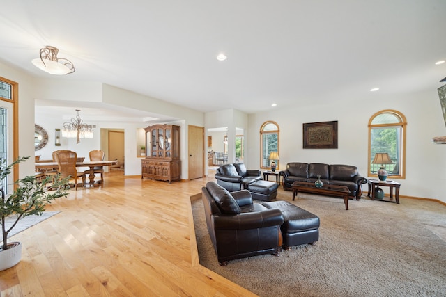 living room with a chandelier and light hardwood / wood-style flooring