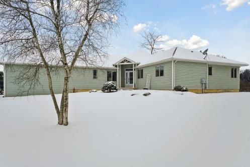 view of snow covered back of property