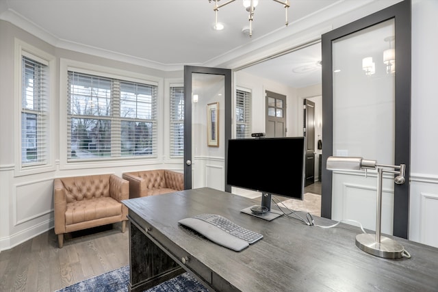 office featuring wood-type flooring, a notable chandelier, and ornamental molding