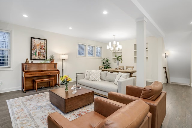 living room featuring a chandelier and dark hardwood / wood-style floors