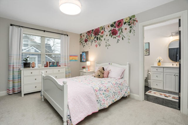 bedroom with light carpet and ensuite bath