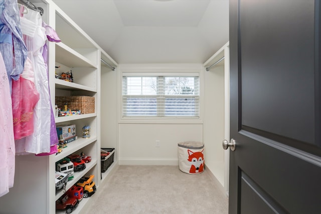 walk in closet featuring light colored carpet