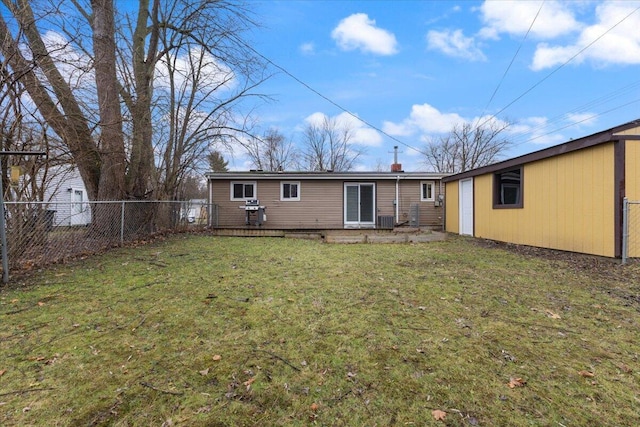 back of house with a lawn