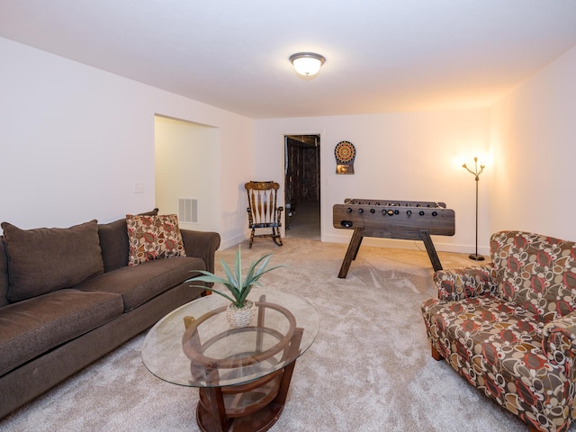 living area with baseboards, visible vents, and carpet flooring