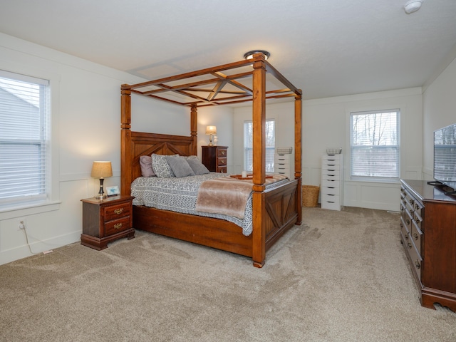 bedroom featuring light colored carpet