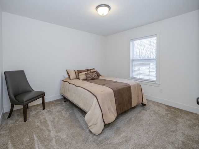 bedroom with light carpet and baseboards