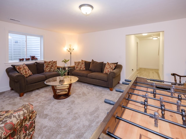 living area featuring carpet floors, baseboards, and visible vents