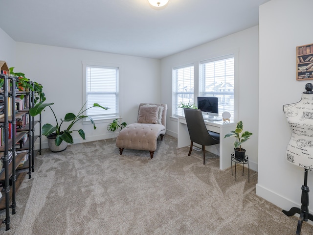 office featuring baseboards and light colored carpet