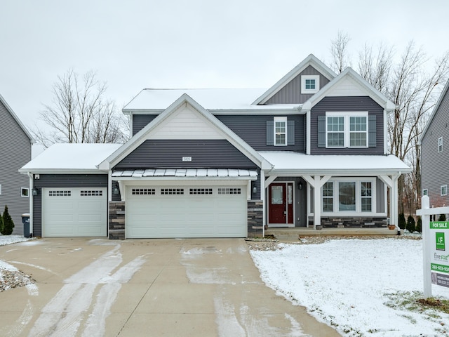 craftsman house featuring covered porch and a garage