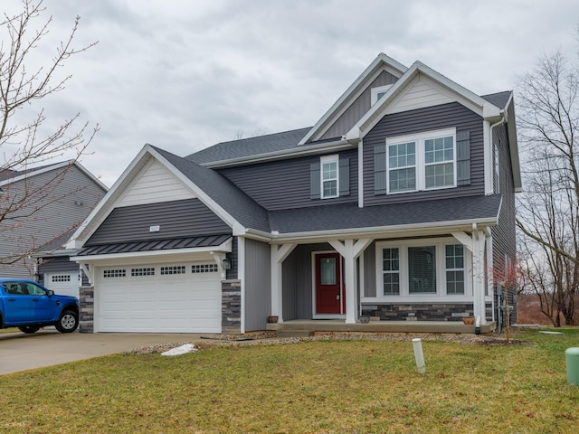 craftsman-style home featuring board and batten siding, a front yard, stone siding, and a garage