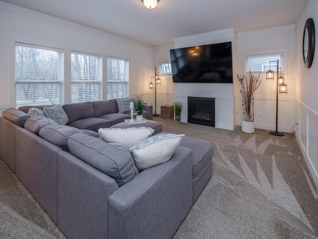 living room featuring a fireplace and light colored carpet