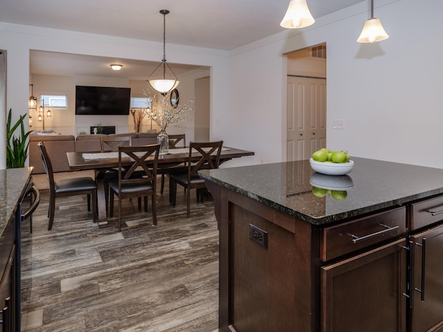 dining area featuring dark wood-style flooring and visible vents