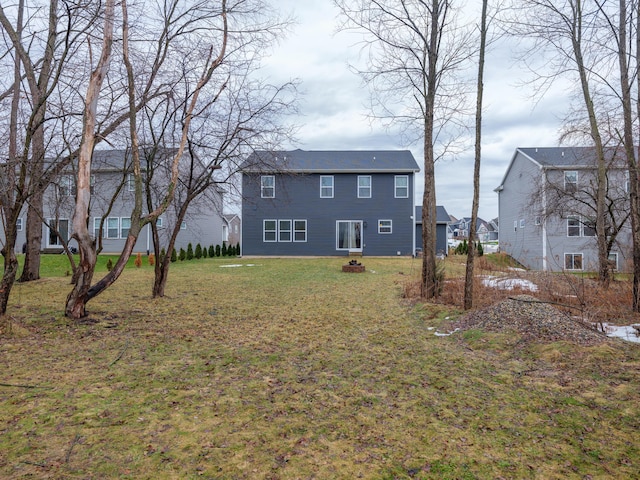 back of property featuring a lawn