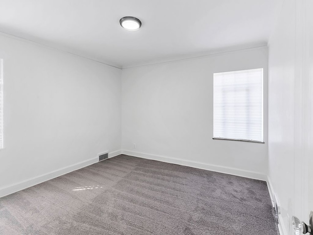 unfurnished room featuring dark carpet