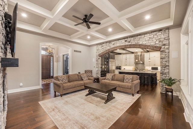 living room with sink, dark wood-type flooring, and ceiling fan with notable chandelier