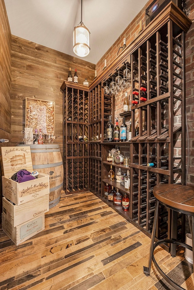 wine area with wood-type flooring and wood walls