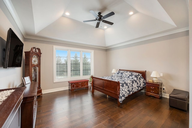 bedroom with a tray ceiling, ceiling fan, ornamental molding, and dark hardwood / wood-style floors