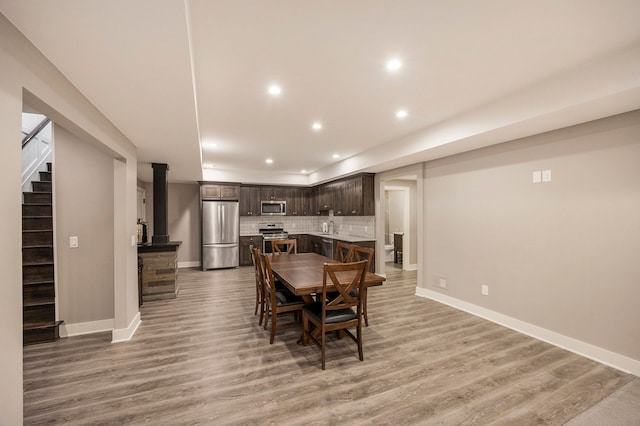 dining room with light wood-type flooring and sink