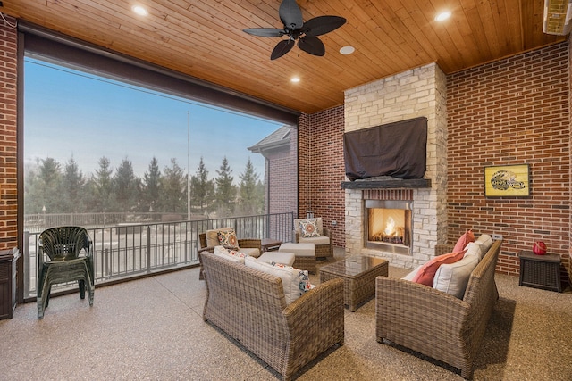 patio terrace at dusk featuring an outdoor living space with a fireplace and ceiling fan