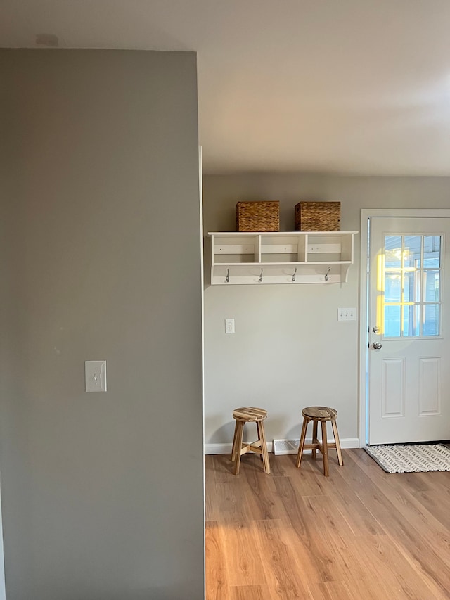 mudroom with light hardwood / wood-style flooring