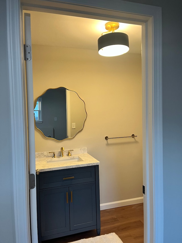 bathroom with vanity and wood-type flooring