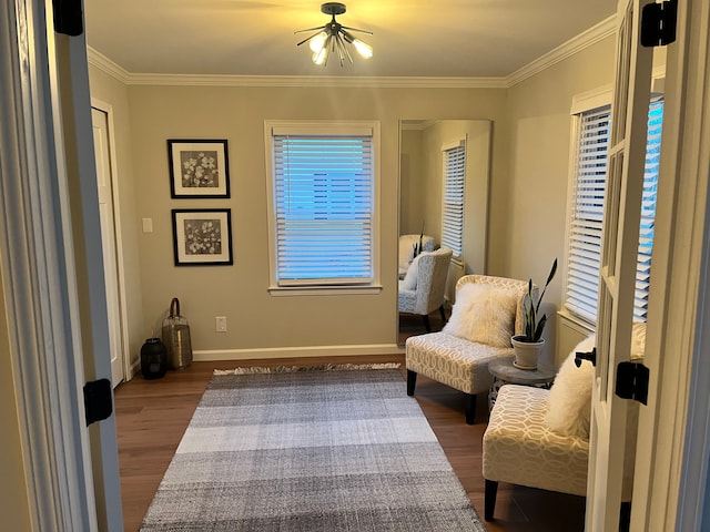 living area featuring dark hardwood / wood-style flooring and crown molding