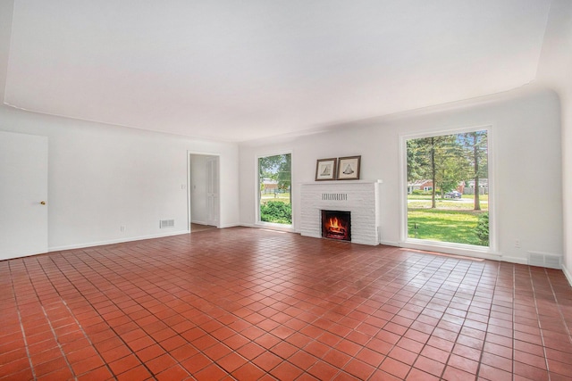 unfurnished living room featuring tile patterned flooring and a fireplace