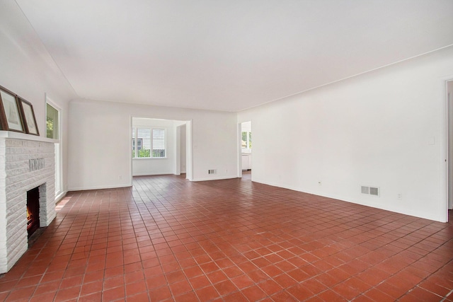 unfurnished living room featuring a brick fireplace