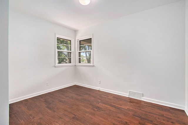 spare room with dark hardwood / wood-style flooring