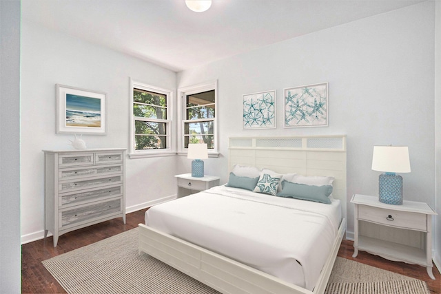 bedroom with dark wood-type flooring