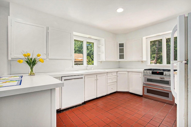 kitchen featuring white cabinets, white appliances, and sink