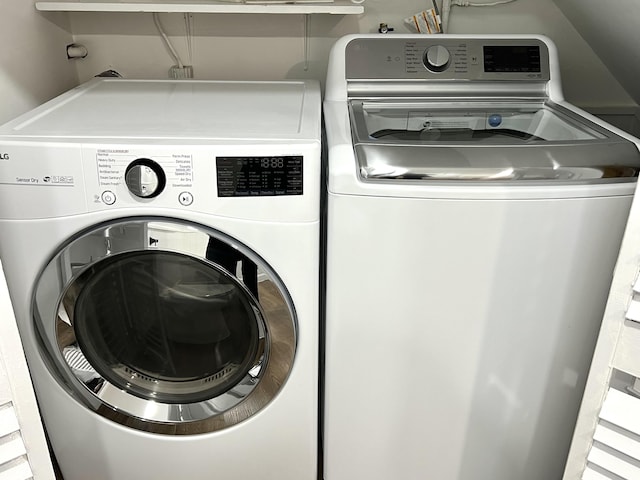 clothes washing area with washing machine and clothes dryer