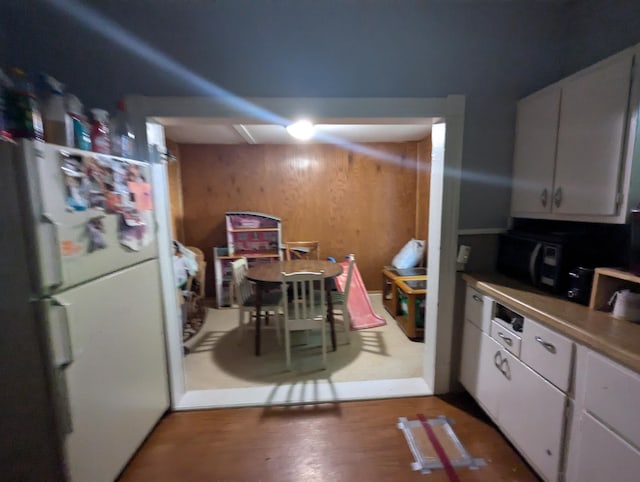 kitchen with white fridge and white cabinetry