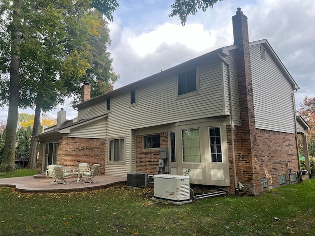 rear view of house with central AC, a patio area, and a lawn