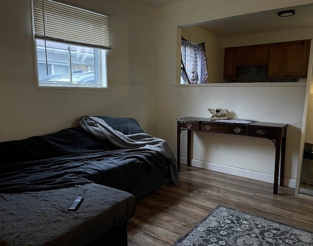 bedroom with dark wood-type flooring