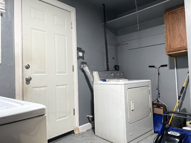 clothes washing area with cabinets and washer / clothes dryer