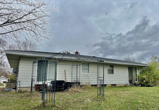 rear view of property featuring a yard