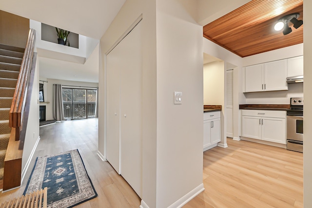 hall featuring light hardwood / wood-style floors and wooden ceiling