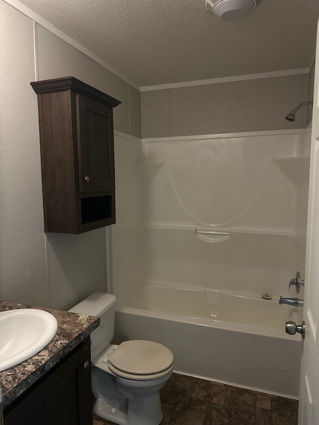 full bathroom with bathing tub / shower combination, vanity, a textured ceiling, and toilet