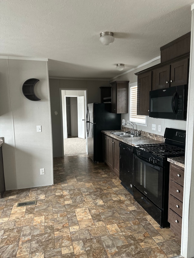 kitchen featuring dark brown cabinetry, sink, and black appliances