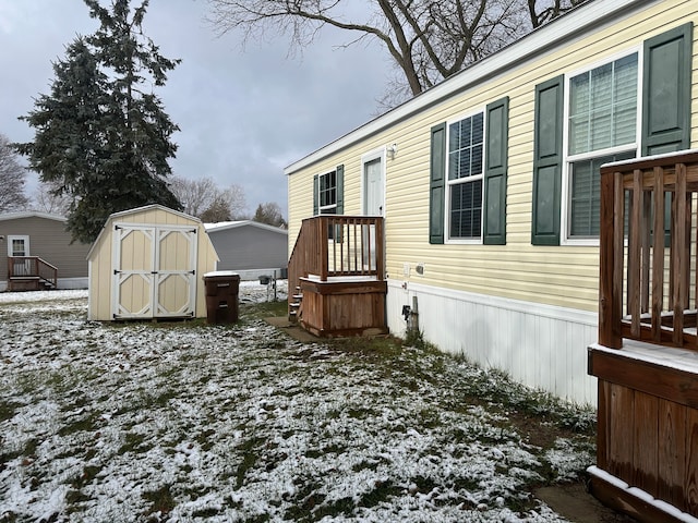 snowy yard with a shed