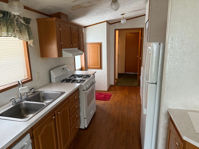 kitchen with dark hardwood / wood-style flooring, white appliances, a textured ceiling, crown molding, and sink