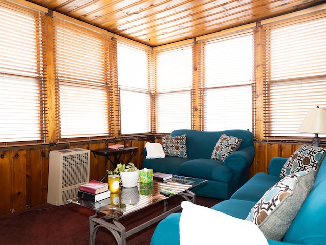 carpeted living room with wood ceiling