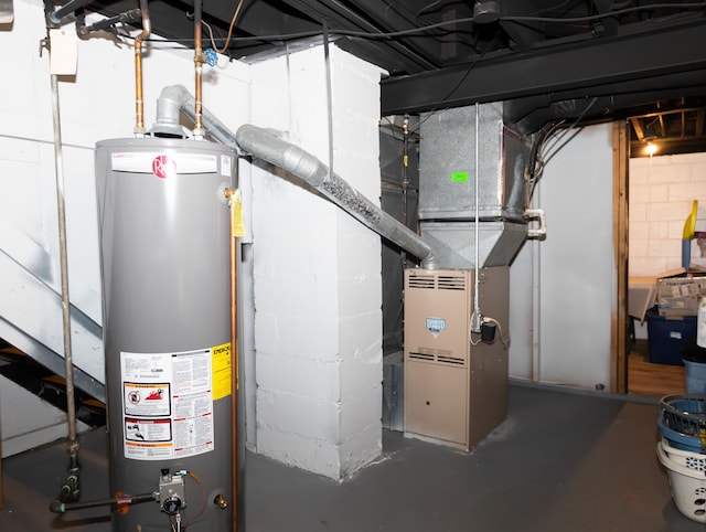 utility room with heating unit and water heater