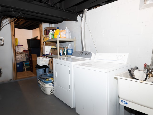 laundry area featuring washer and clothes dryer and sink